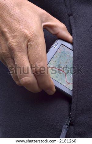 Close up of man taking PDA from the pocket of a fleece outdoor jacket.