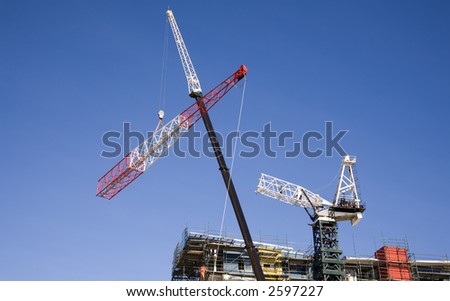 Sections of the crane being lowered to the ground to be carried away by truck