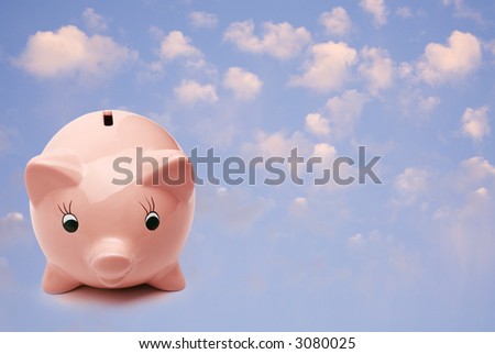Pink piggy bank against blue sky with pink clouds. Concepts of saving for holidays, savings and a bright future.