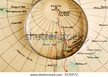 Old map of South Pole with magnifying glass over Ross Ice Shelf, which is said to be melting due to global warming. Map is from 1909 and is out of copyright.