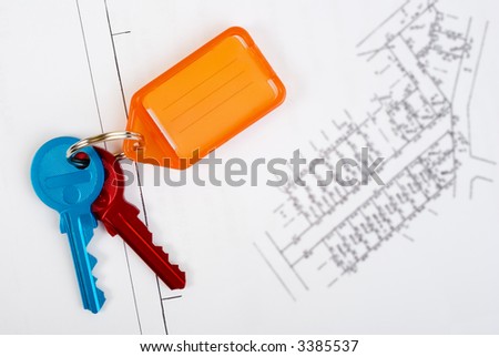 Plans for new subdivision and colourful keys. Keys are sharp, plan has been blurred. Space for text.