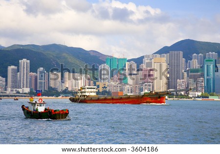 Hong Kong Harbor with a couple of ships, Hong Kong Island and high density apartments in the background.in the background.
