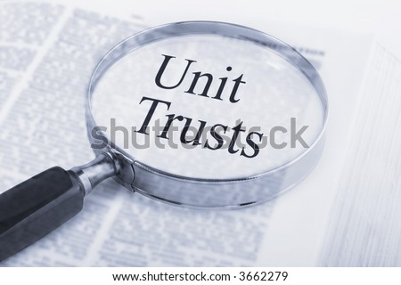 Dictionary with magnifying glass emphasising the words Unit Trust, see others from this series in our portfolio.