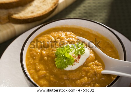 Hearty bowl of lentil soup with a dollop of sour cream and 100% wholemeal bread. Low calorie, full of fibre, inexpensive and warming. What more could anyone want?