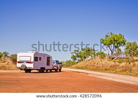 A typical outback touring rig heads back onto the road at a Western Australian rest area.