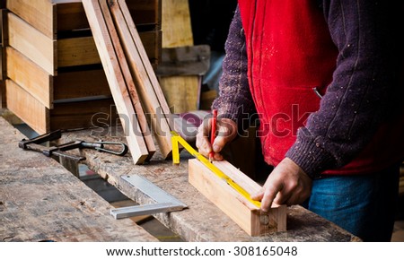 Man working in a carpenter with solid wood