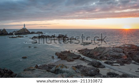 La Corbiere Lighthouse at sunset on Jersey in the Channel Islands, in the English Channel.