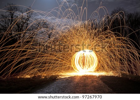 Abstract Image of Burning Wirewool being used to make orb like light trails at Night