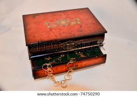 Jewelry box with open drawer and gold chain