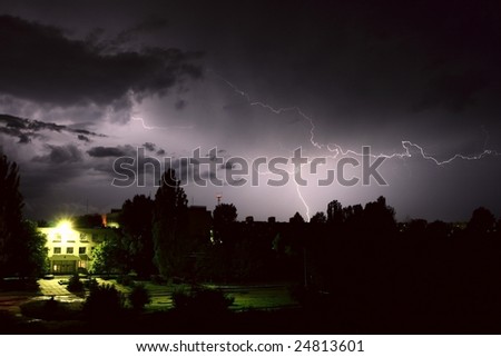 Lightning during night thunderstorm. on city
