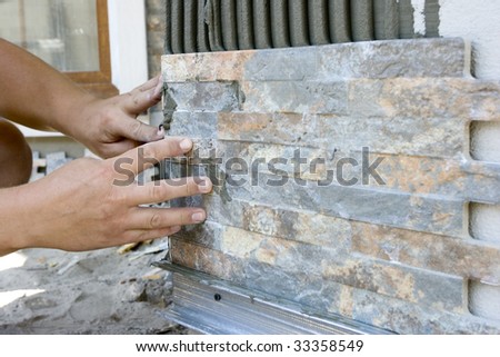 tiler install ceramic tile on wall