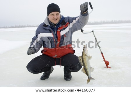 Winter ice fishing. The fisherman fishes from an ice-hole