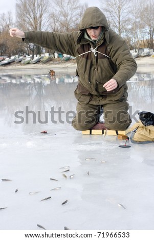 ice fishing competition. competitor catches the fish on Ice Fishing Jig with bloodworm