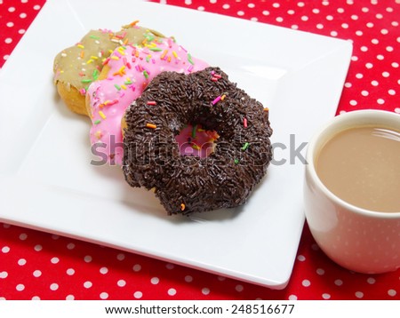 donut and milk coffee on red tablecloth