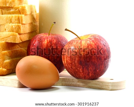morning breakfast with egg and bread and red apples selective focus