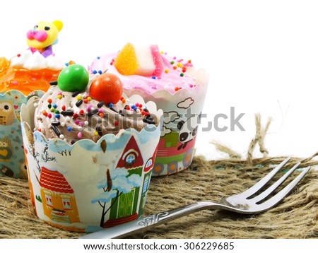 closeup of cupcake in sweet paper cup on white background