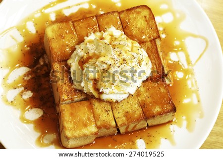 Honey bread with cream on white dish.