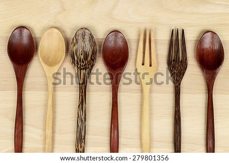 Wood spoons and fork decorate on wood.