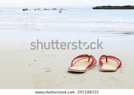 Shoe, Sand and ripples on beach Thailand.