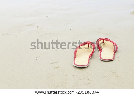 Shoe, Sand and ripples on beach Thailand.