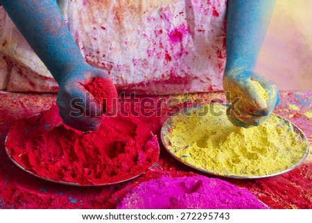 Midsection of person holding powder paints during Holi festival