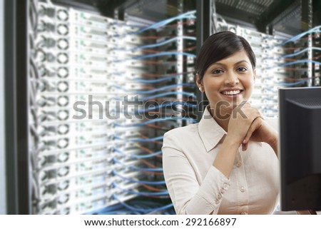 Portrait of smiling business woman sitting in server room