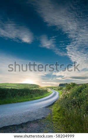 Curved track leading to a summer sunset in Scotland