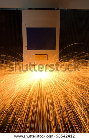 Sparks from a computer controlled machine which cuts metal with great accuracy.