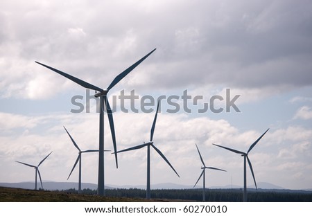 Wind turbines silhouetted on a wind farm in Scotland, Europe.