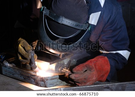 TIG welder uses torch to make sparks during manufacture of metal equipment.