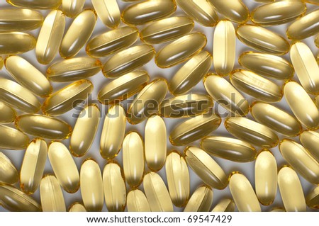 Gold medical capsules as abstract pattern in close up
