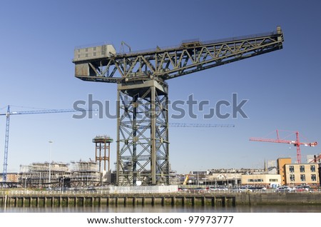 Modern and traditional cranes on the landmark quayside of River Clyde in Glasgow, Scotland