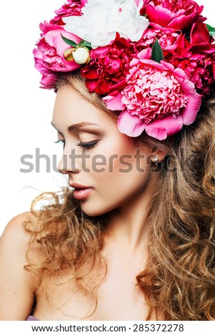 Fashion Beauty Model Girl with flowers in the hair. Bouquet of peonies. Perfect skin