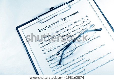 Employment contract with clipboard and glasses