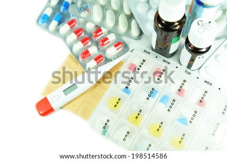 Medical kit with plaster, thermometer and various medication isolated against white
