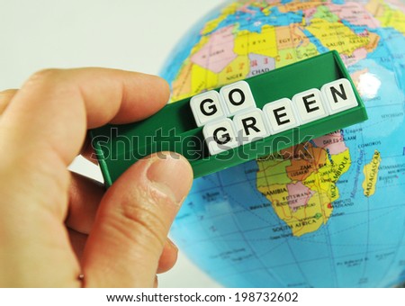 Go green concept with key words and Earth globe in the background