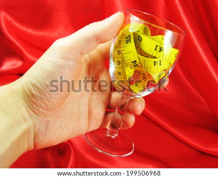 Wine glass and measuring tape representing liquid diet
