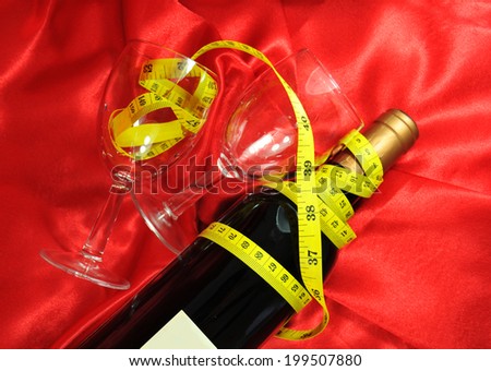 Drinking responsibly concept with bottle of wine, glasses and measuring tape