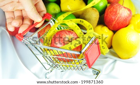 Healthy food concept with shopping trolley and fruits