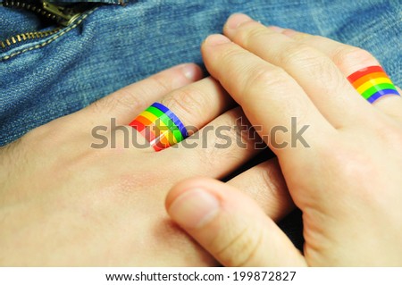 Gay marriage concept with hands and rainbow rings