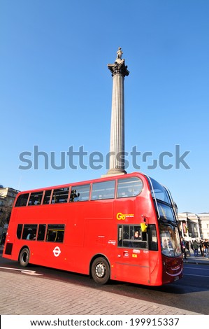 LONDON, UK - NOVEMBER 19, 2011: Traditional double-decked red bus with tourists sightseeing in London, England