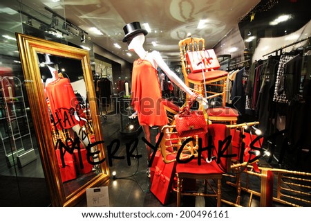 COPENHAGEN, DENMARK - DECEMBER 18, 2011: Glamorous fashion shop window with mannequin and clothes on display at Christmas
