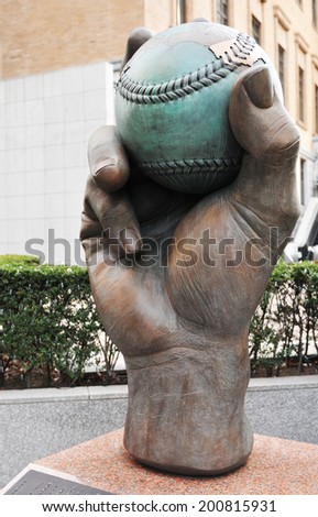 TOKYO, JAPAN - DECEMBER 28, 2011: Statue of hand holding baseball ball in Tokyo, Japan