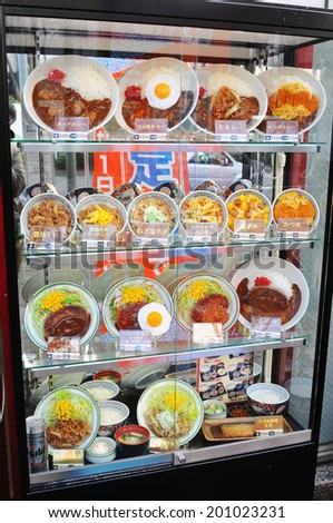 TOKYO, JAPAN - DECEMBER 28, 2011: Plastic food on display in restaurant\'s window on the streets of Tokyo