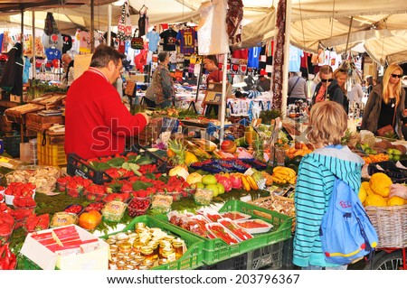 ROME, ITALY - MARCH 29, 2012: Tourists shopping for traditional Italian products in Campo dei Fiori, famous outdoor market in central Rome