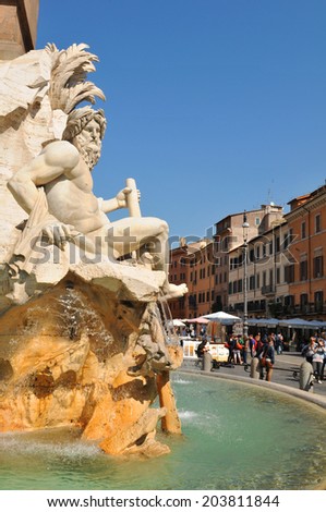 ROME, ITALY - MARCH 29, 2012: Tourists sightseeing the Egyptian obelisk in Piazza Navona, major touristic attraction in the historical centre of Rome