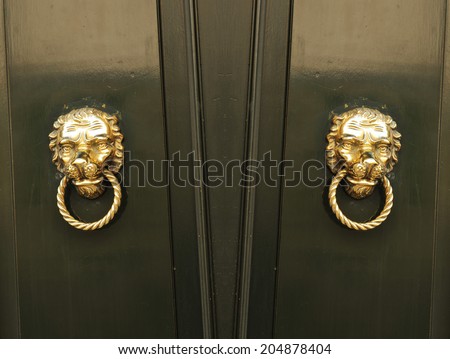 Abstract collage of old door with symmetrical golden door knobs