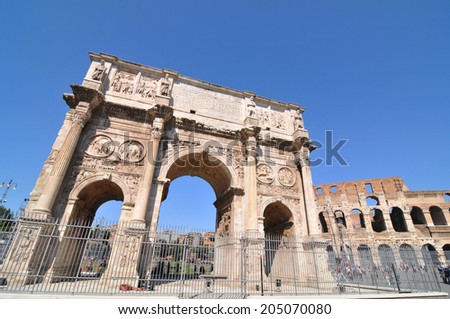 ROME, ITALY - MARCH 30, 2012: Tourists visit the famous Arch of Constantine, a triumphal monument in Rome, situated between the Colosseum and the Palatine Hill.