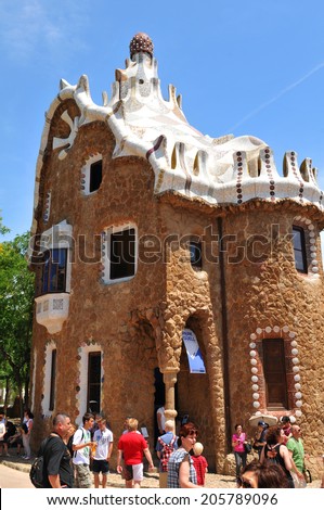 BARCELONA, SPAIN - JULY 6, 2012: Tourists admire Gaudi\'s architectural masterpieces in Park Guell