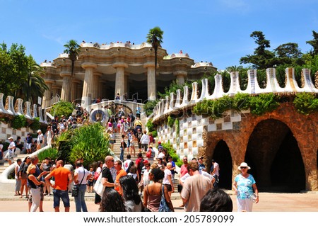 BARCELONA, SPAIN - JULY 6, 2012: Tourists admire Gaudi\'s architectural masterpieces in Park Guell